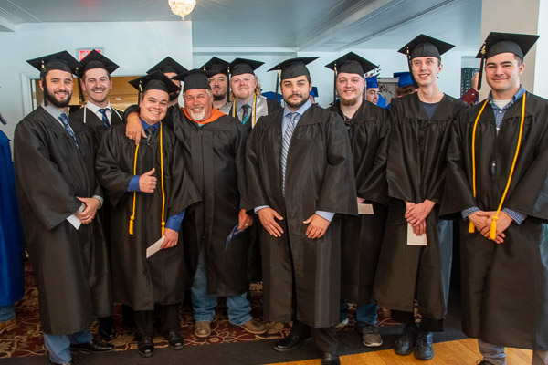 Todd S. Woodling, assistant professor of building automation technologies/HVAC electrical, gathers with grads of the building automation technology major.