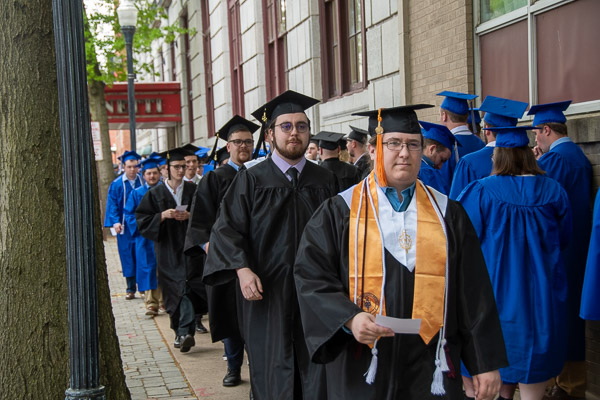 Students make their way to the end of a long lineup of Saturday afternoon grads on William Street.