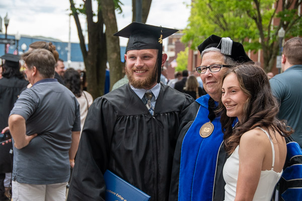 Two Saturday grads – one in the morning and the other in the afternoon – have their photo taken with the president following the latter ceremony.