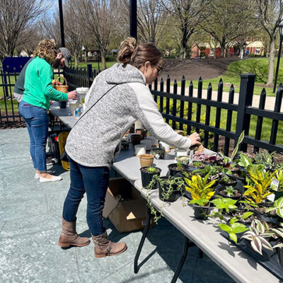 Advisers accustomed to cultivating student involvement turn their green thumbs loose on something just for them, thanks to a potting bench on the CC patio. From foreground are Summer L. Bukeavich, assistant professor of business administration/management and marketing, who lends her expertise to the Penn College Business Club; Jessica U. Oberlin, librarian for information technology initiatives, co-adviser to Penn College Women in Construction; and lacrosse coach Jordan G. Williams, representing the Student Athlete Advisory Council.