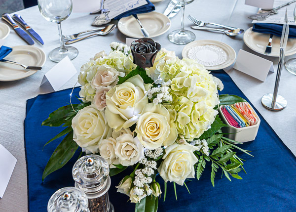 Centerpieces by Karen R. Ruhl, an award-winning horticulture instructor, topped off by a metal rose, grace each table ...