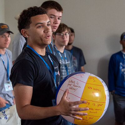 Following the welcome, students divided into smaller groups for more individualized interactions. Noah Rudisill-Warner, of York, welding & fabrication engineering technology, holds the traditional beach ball covered with icebreaker prompts. Noah’s question and answer? “What’s your favorite candy?” ... “Skittles!”