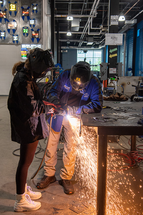 A young welder’s miniature metal sculpture receives some finishing touches with the help of instructor Timothy S. Turnbach ... 