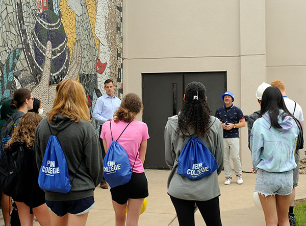 Jason K. Bogle (at left background), the college's director of construction and planning, leads a group tour of renovations underway at the Physician Assistant Center. Accompanying the campers is architecture instructor Daniel L. Brooks (in blue hard hat).