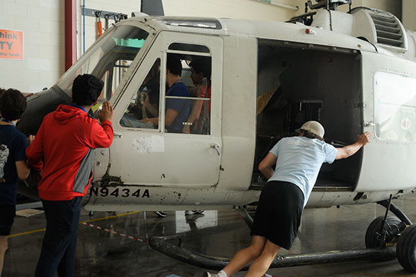 How many teenagers get to wheel a retired Bell UH-1B military helicopter from an airport hangar ...