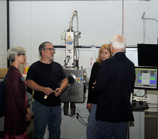 Offering a peek at the electron beam welder to the day's governmental guests are (at left) Kathy D. Chesmel, assistant dean of materials science and engineering technology, and welding instructor Michael R. Allen.