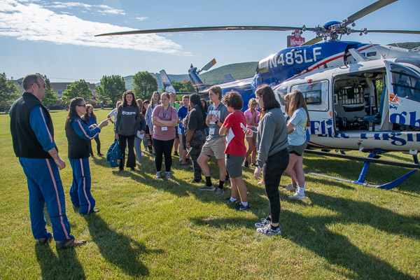Pilot Scott Slade (left) and flight nurse Faith Worthington answer the questions of Health Careers Campers during a stop by a Life Flight medical evacuation helicopter on the Madigan Library lawn.