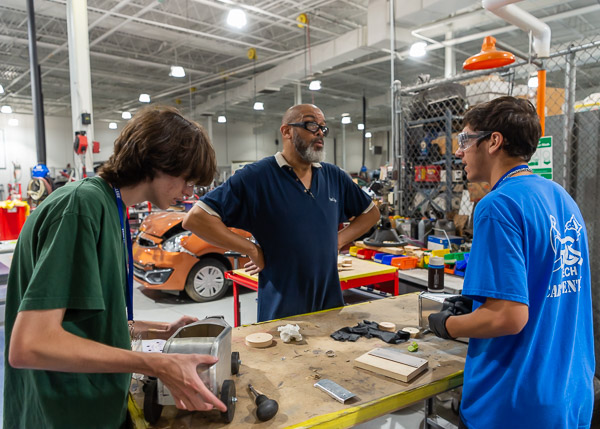 Automotive instructor Eric D. Pruden (center) provides individualized attention as a hands-on project takes shape.