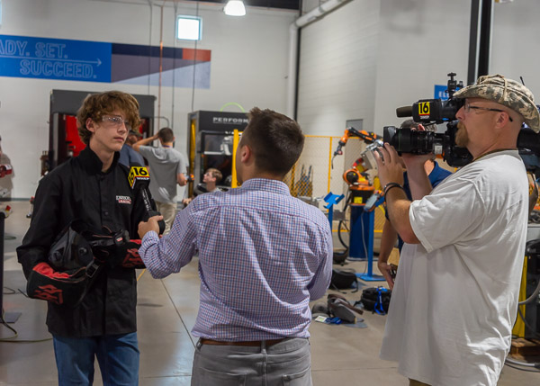 Newswatch 16 reporter Chris Keating and videographer Tom Durant record an interview with a rising ninth grader in the welding lab.