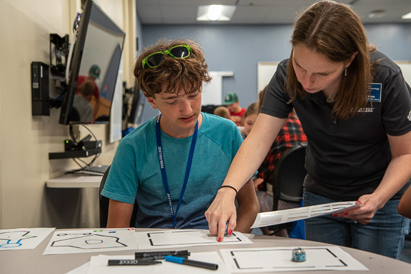 Melissa A. Webb, technology instructor and information literacy/course coordinator, works with a young Tomorrow Maker.