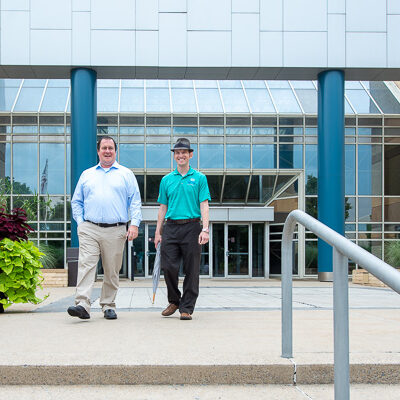 Weaver and Webb emerge from the Breuder Advanced Technology & Health Sciences Center for a campus stroll to other sites.