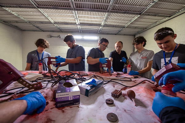 Students learn about magnetic particle testing and inspection with the assistance of Mark N. Hurd (third from right), instructor of non-destructive testing and welding.