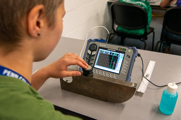 A non-destructive testing “camper” engages in calibrating ultrasonic equipment ...