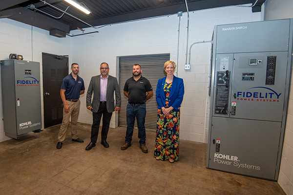 Standing between two of the three KOHLER units donated by Fidelity Power Systems to Pennsylvania College of Technology are (from left) Fidelity's Ryan Hannigan, operations support, and Charlie Hicks, vice president service operations; and, from Penn College, John D. Motto, diesel equipment technology instructor; and Elizabeth A. Biddle, senior corporate relations director. 