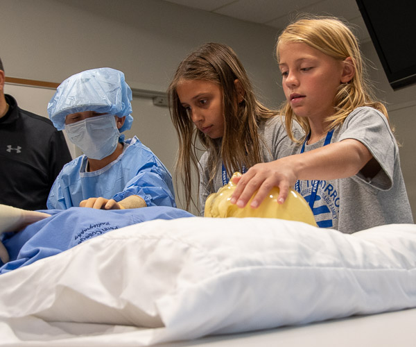 In the radiography lab, campers get a hands-on feel for “Pixy,” the manikin used by radiography students to gain experience taking real X-rays. Pixy contains manmade bones and organs to provide realistic images.