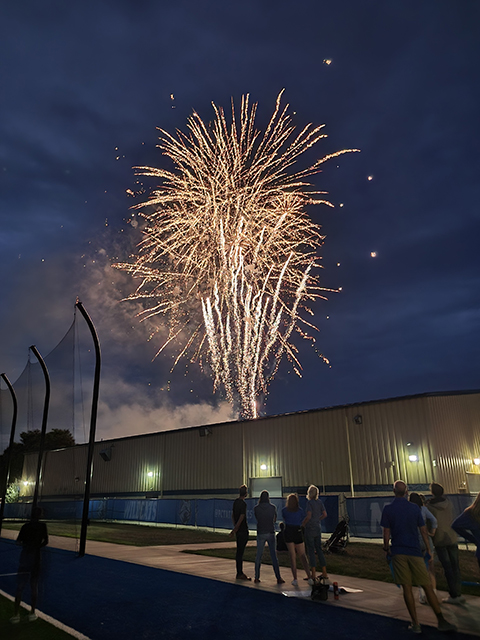 The illuminating show, set off from the south side of campus, accents the exterior Field House lighting. (Photo by Kimberlee R. Rusczyk)