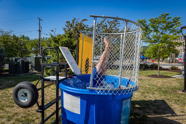 Rob Cooley, associate professor of anthropology/environmental science, takes a no-doubt-refreshing drop into the drink due to a hurler's precise hand-eye coordination. Other dunk-tank volunteers included Jordan G. Williams, lacrosse coach, and Scott E. Kennell, director of athletics.