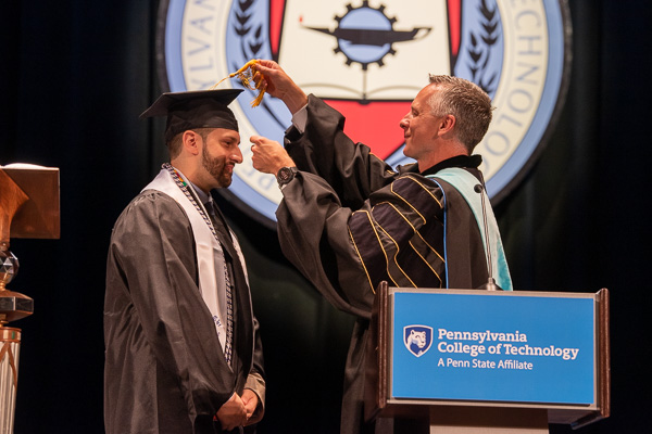 Reed turns Bilbao's tassel from right to left, asking the speaker's classmates to follow 