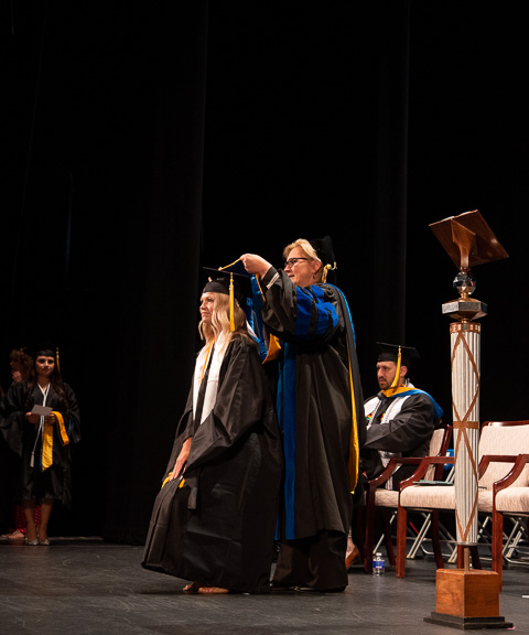 Alp hoods Brooke Morgan Confer, a bachelor's/master's graduate in physician assistant studies, and a recipient of the Academic Vice President and Provost's Award ...