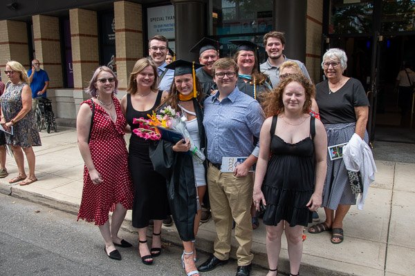 The celebrating Moore clan includes new physician assistant studies grad Gabrielle E. (center), and behind her (with caps), dad Todd (student affairs marketing specialist) and mom Shelley L. (senior director of the Center for Career Design).