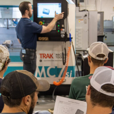 Students follow along with a sample programming task on the new vertical machining center.