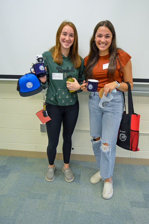 Julia M. Colton (left), a pre-nursing student from Troy, and Amber K. Hakes, of Williamsport, enrolled in pre-dental hygiene, show off their takeaways from the Wildcat Events Board table ...