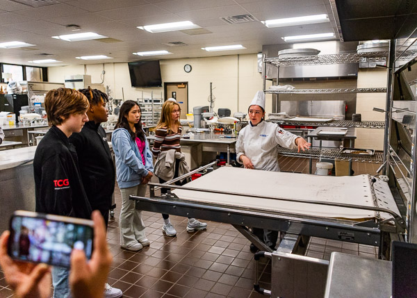 Smith demonstrates one of the ovens in a baking lab ...