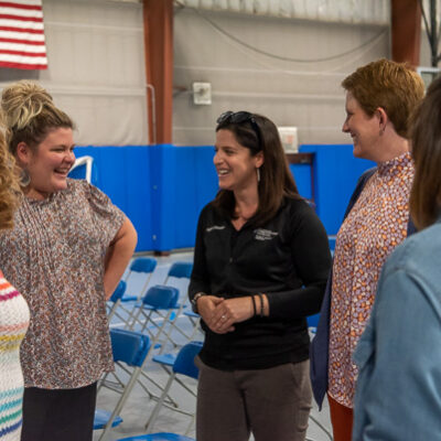 Socializing after the video presentation: Victoria Hurwitz (at center in black), director of physical therapist assistant, and Christine A. Tilburg (right), PTA clinical director, chat with Pulizzi (second from left) and other members of the People & Culture staff.