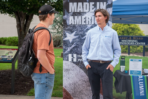 Gabe G. Sharkey (right), ’22, manufacturing engineering technology, returns to his alma mater for the event and converses with Connor Jay McWilliams, a welding & fabrication engineering technology student from Coatesville. Sharkey is an applications engineer with Hardinge Inc.