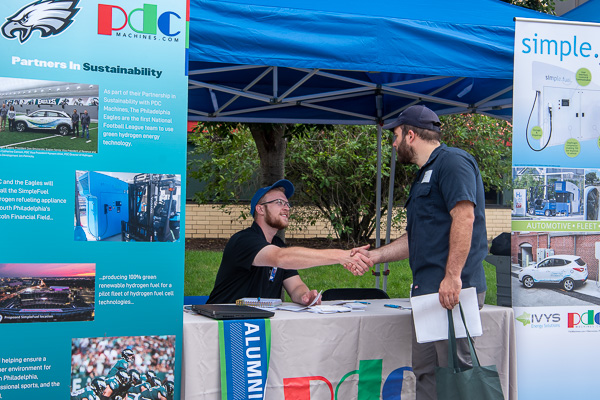 Connections made ... in the shade of a pop-up tent. Alumnus Christopher M. Schweikert, a manufacturing engineer at PDC Machines Inc., confidently shakes the hand of Paul Thomas Wardach Jr. (right), a metal fabrication technology student from Clarks Summit. Schweikert graduated in Spring 2021 with degrees in manufacturing engineering technology and automated manufacturing technology. 