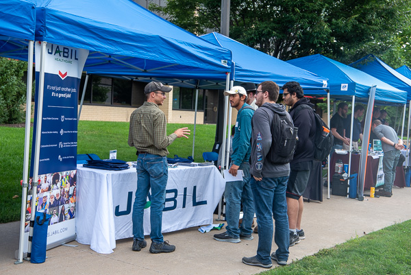 Students lend a collective ear to Bryan Harlacker, a 2000 manufacturing engineering technology alumnus working as a lead supervisor at Jabil Healthcare's Elmira, N.Y., facility.