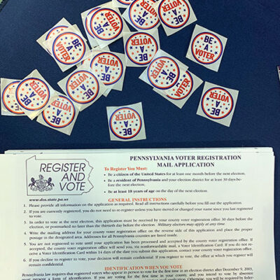 Voter registration material and stickers encourage involvement in the electoral process. Deadline alert: Oct. 24 is the last day to register before the Nov. 8 midterm election in Pennsylvania.