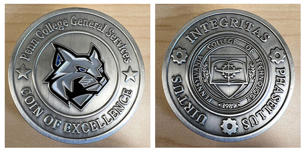 Both sides of the General Services "Coin of Excellence" are represented in the department's recognition award.