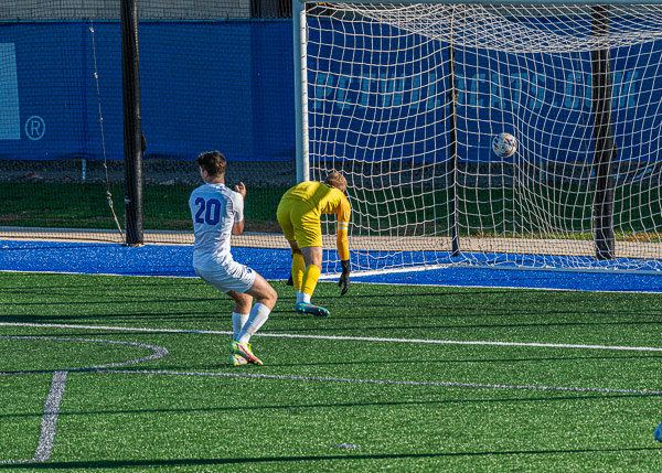 Nathan Schwartz (20) hammers home the Wildcats' only men's goal of the day, his first of the season.