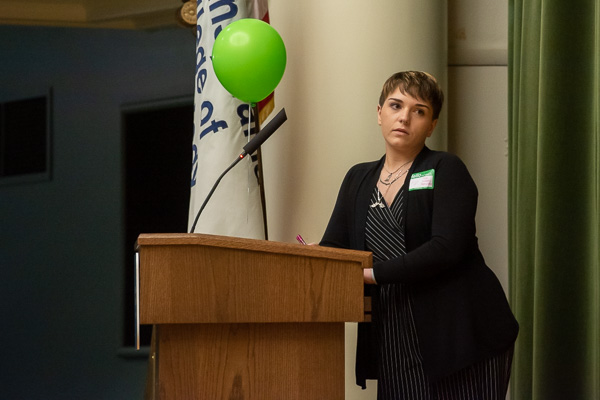 During a stint as moderator, Little – alongside a green balloon symbolizing mental health – listens intently to panelists’ points.
