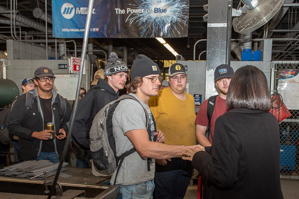Bendapudi talks with welding students in the Lycoming Engines Metal Trades Center.