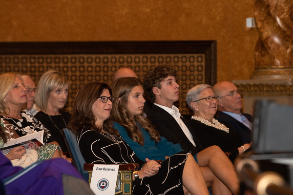 The Reed family, alongside President Emeritus Gilmour and husband Fred, listen to remarks.