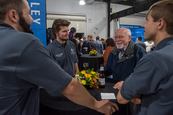 Donor Larry A. Ward, whose name adorns the Machining Technologies Center, shares a laugh with students while imparting his years of wisdom.