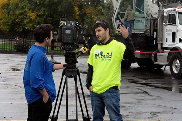 A student from North Pocono High School talks with Keating near Zartman Construction Inc.'s crane-operating activity.
