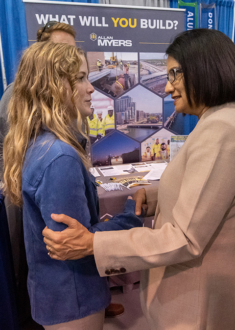 Robin L. German, a first-year student in construction management from Red Lion, enjoys an unexpected encounter with Penn State President Neeli Bendapudi during the Fall Career Fair at Penn College.