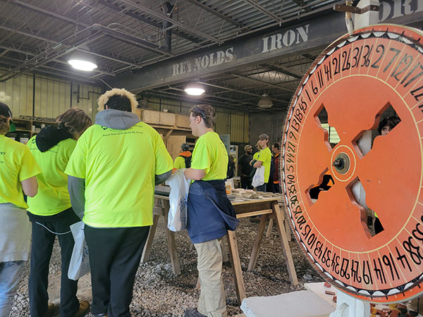 Inside the lab, visitors spin the wheel for prizes made by the ConCreate Design Club (a student chapter of the American Concrete Institute).