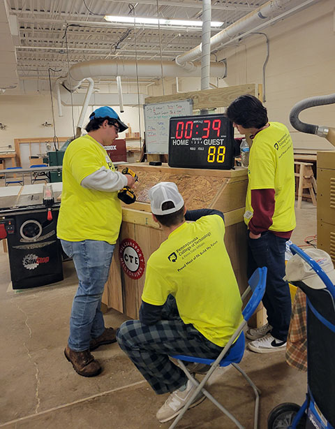 Trying to beat the clock – and one another – in a power-drill activity sponsored by the Pennsylvania Builders Association Endorsed Trade Program