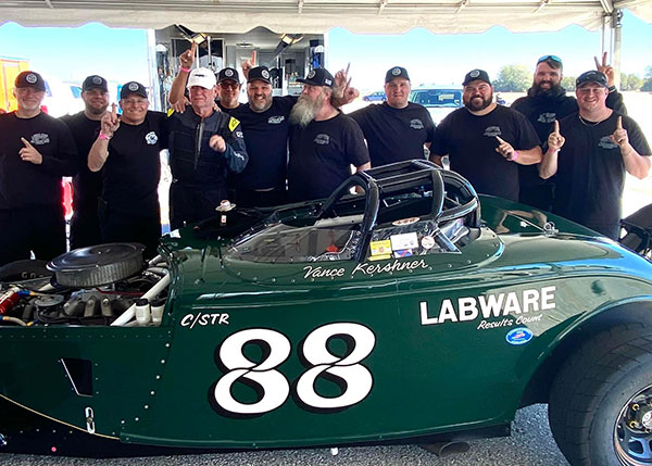 Godinez (far right) celebrates with the rest of the crew from The Garage Shop after a Ford Roadster the company fabricated topped 200 mph during a sanctioned land speed race in Blytheville, Ark.