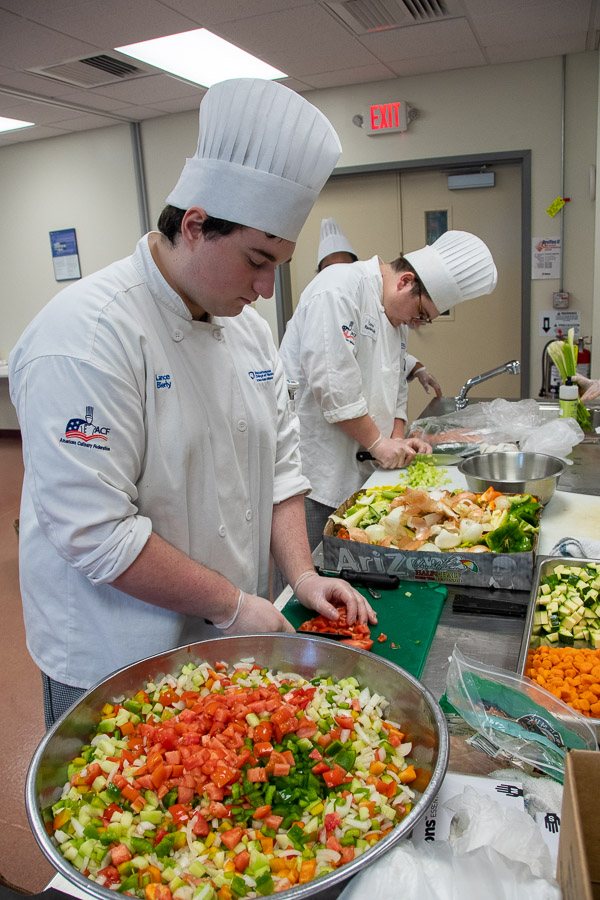 Bierly (left) and Raudenbush prepare vegetables for a colorful salad.