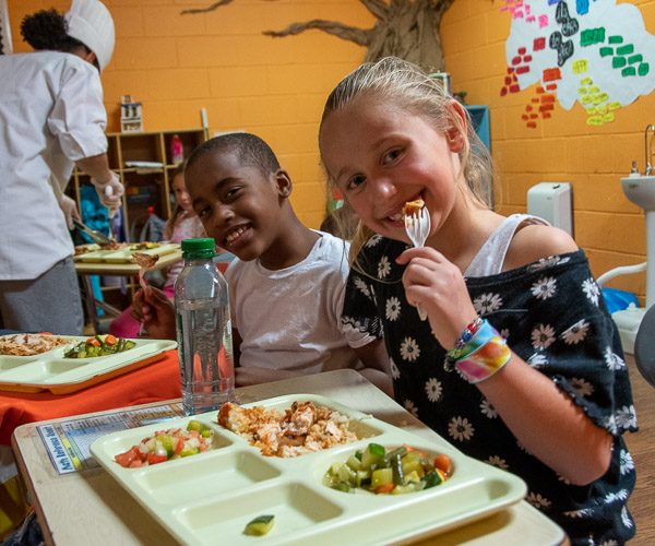 Children relish their chef-made meal.