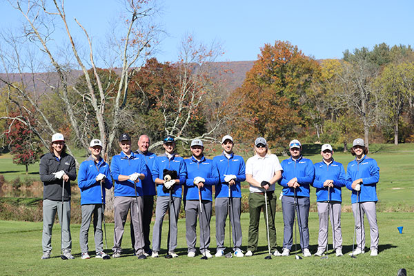 A hatless coach Robert J. Lytle lines up with Wildcat golfers, past and current.