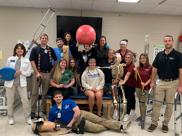Having fun while promoting National Physical Therapy month, physical therapist assistant students and staff show props of their profession.