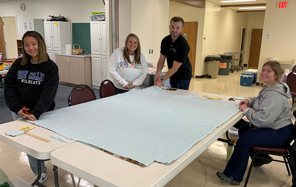 PTA Club members contribute to a “future made by hand” by contributing their handiwork to a Project Linus blanket. From left: Emily Smith, Lauren Bennett, Nathan M. Wolf and Selena A. Martinez.