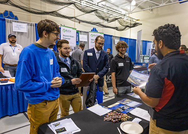 HVAC and building automation students talk with a representative of Innovative Refrigeration Systems Inc., Lyndhurst, Va., in Penn College's Bardo Gymnasium. (Photo by Frank T. Kocsis III, student photographer)