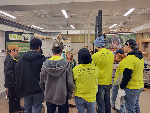 The Keystone Wood Products Association's Stephanie Phillips-Taggart talks with students in a carpentry lab.